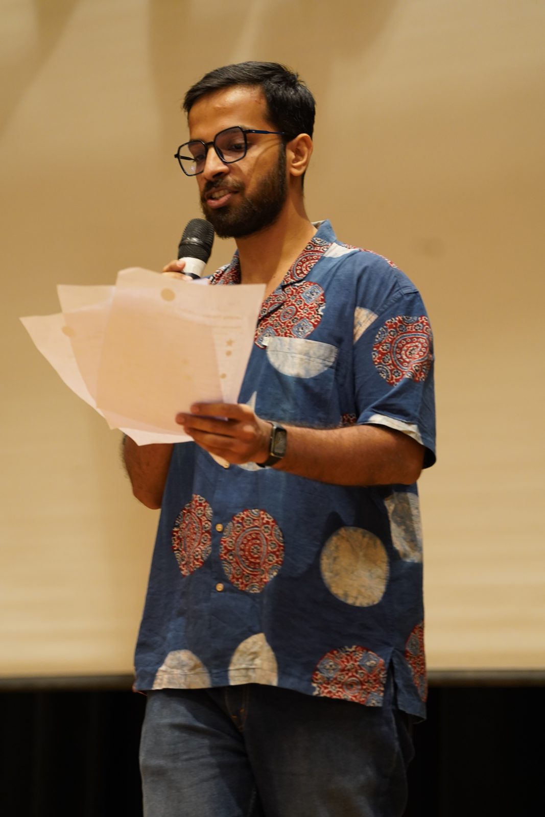 A fellow sharing reflections at the mic